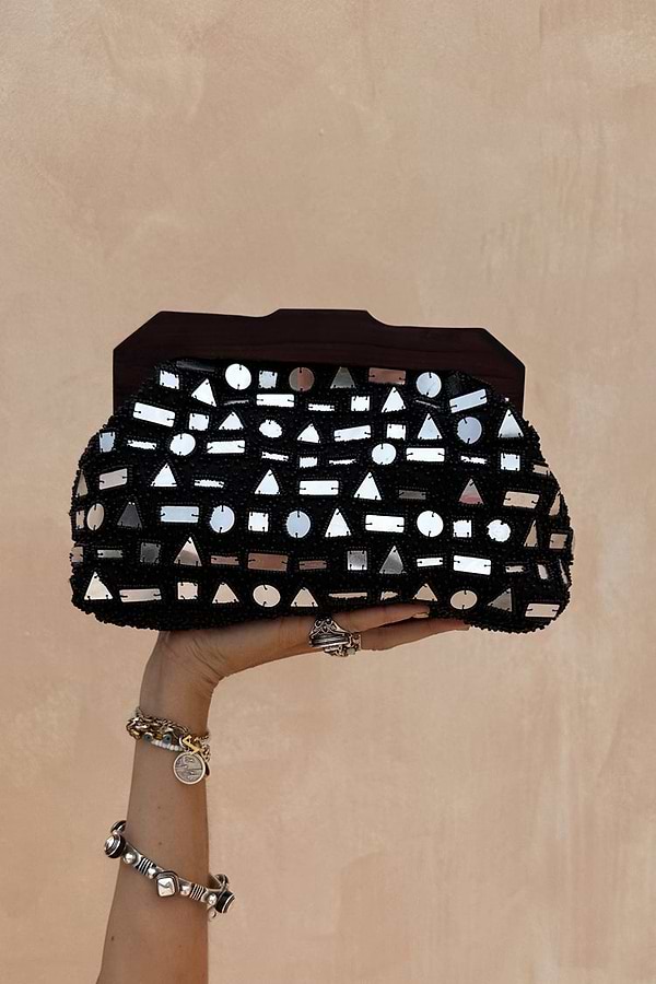 Black Beaded Mirror Bag featuring geometric silver mirrors and a dark wooden handle, held up by a hand.