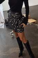 Black Beaded Mirror Skirt with geometric glass embellishments and a wrap tie fastening, styled with black knee-high boots.