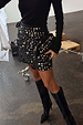Black Beaded Mirror Skirt with geometric glass embellishments and a wrap tie fastening, styled with black knee-high boots.
