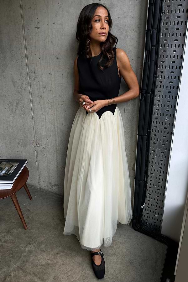 Black and Cream Monika Dress with a scalloped corset-style top and pleated tulle skirt, worn by a model.