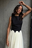 Thumbnail for Black and Cream Monika Dress with a panelled corset top and pleated tulle mesh skirt on a model.