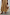 Thumbnail for Camel Monika Dress with a pleated skirt, styled with a beaded fringe bag and tan kitten heel sandals.