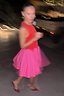 Thumbnail for Red and Pink Mini Monika Dress with a corset-style bodice and pleated skirt in a motion-blurred street style shot.