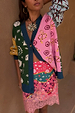 Morocco Martha Knit Cardigan with sun, eye and snake motifs in a multi-colour print, styled with a pink lace mini skirt.