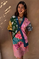 Morocco Martha Knit Cardigan in a multi-colour sun and eye print with blue hems and a button-up front.