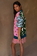 Morocco Martha Knit Cardigan with colourful sun and eye motifs, layered over a pink lace slip dress.