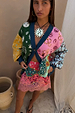 Morocco Martha Knit Cardigan in a multi-coloured sun and eye print with blue hems, styled with a lace mini skirt.