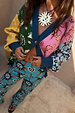 Morocco Martha Knit Cardigan featuring a multi-colour print with sun, snake and eye motifs and blue ribbed trims.