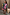 Thumbnail for Pastel Morocco Mini Maeva Skirt with abstract motifs and pink lace trim, worn with a colour-block cardigan.