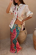 Morocco Charms Marley Shirt in sheer cream with sun and snake motifs, paired with a colourful patterned maxi skirt.