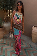 Pastel Morocco Dorris Skirt with abstract print blocks, tan sun motifs and eyes, shown on a model in a patio.