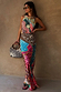 Pastel Morocco Dorris Skirt in a colourful sun and snake print, styled as a co-ord against a neutral wall.