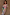 Thumbnail for Multi-wear Pastel Morocco Tilly Dress featuring metallic flecks and sun motifs, styled off-the-shoulder with a beaded bag.