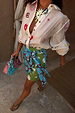 Morocco Mini Wrap Skirt with green and blue sun face prints, featuring a wrap tie fastening for a multi-wear look.