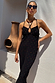 Multi Spot Megan Dress in black plisse with colourful flecks and a crossover strappy neckline on a model.