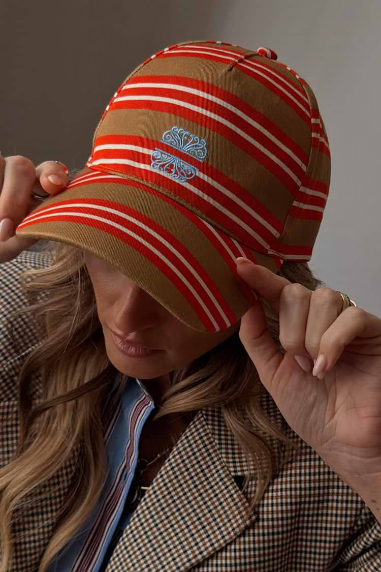 Cotton Multi Stripe Cap in tan brown with red stripes and blue NFD embroidery, styled on a model.