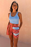 Thumbnail for Multi Stripe Tate Shorts featuring red, blue and brown stripes, worn with a blue ribbed vest and tan sunglasses.