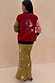 Mystical Martha Cardigan with embroidered motifs on a red back and contrast sleeves, styled with a matching patterned skirt.
