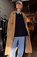 Navy Book The Flight Jumper with red text, styled with a tan trench coat and blue striped trousers for a London look.