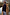 Thumbnail for Navy Book The Flight Jumper with red slogan text, layered under a tan trench coat with striped trousers.
