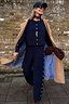Navy Studded Knit Jogger co-ord with silver side studs, styled with a camel trench coat, navy cap and sunglasses.
