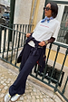 Navy Pinstripe Arden Trousers styled with a white graphic tee and matching blazer for a smart-casual London look.
