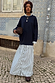 Navy knit jumper dress featuring a blue striped cotton skirt with button-down detail and midaxi length.