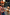 Thumbnail for Rust orange NFD Kids Diamond Bomber with green and red diamond patterns on a child holding a dog’s paws.