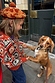 Rust orange NFD Kids Diamond Bomber with green and red diamond patterns on a child holding a dog’s paws.