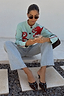 Octopus Cardigan in blue knit with red embroidery and blanket stitching, styled with light blue jeans.