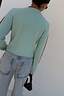 Octopus Cardigan in soft blue knit featuring red contrast blanket stitch detailing on the neckline and sleeves.