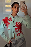 Blue Octopus Cardigan featuring red embroidered motifs and blanket stitch detailing, shown in a casual mirror selfie.
