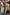 Thumbnail for Olive Buckles Mesh Dress featuring western horseshoe motifs, styled under a tan trench coat on a city street.