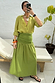 Olive Lola Mid-axi Dress styled as a multi-wear skirt with an olive shirt and ruched waist detail.
