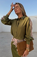 Olive & Pink Lace Marley Shirt with pink lace sleeve panels, styled with a matching skirt in a bright outdoor setting.