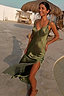 Olive Sofia Dress in olive green satin with tie-knot shoulders and a side split, styled for a summer vacation look.