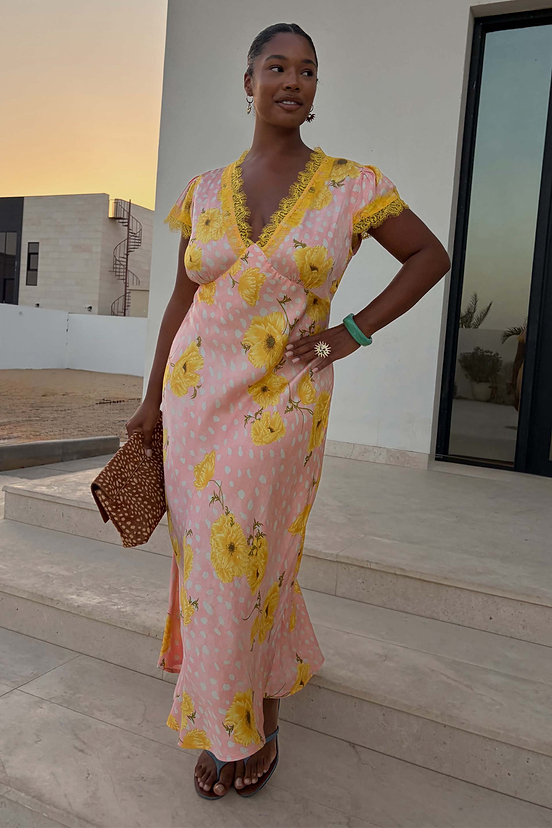 Pink Fawn Poppy Olivia Dress with yellow lace trim and floral deer print, styled with a brown animal print clutch.