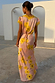 Pink Fawn Poppy Olivia Dress with yellow lace trim and tie-back waist, featuring iconic poppy motifs and deer print.