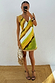 Green Ombre Deia mini dress with earthy yellow tones and textured raffia trim in a mirror selfie.
