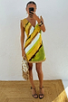 Green Ombre Deia mini dress with earthy yellow tones and textured raffia trim in a mirror selfie.