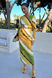 Green Ombre Alba Dress in earthy tones with long sleeves and a beaded cut-out waist, styled for vacation.