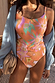 Orange Dreamer Scoop Swimsuit with iconic palm and sun prints and a statement buckle belt, layered with a blue shirt.