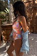 Orange Dreamer Scoop Swimsuit with sun and palm prints, styled with a blue shirt on a 5ft7” model in a UK size 10.