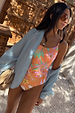 Orange Dreamer Scoop Swimsuit featuring sun and palm prints and buckle waist detail, styled with a light blue shirt.