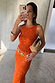 Thumbnail for Orange Sequin Tank Top with a racerback, styled with a matching skirt and chunky gold accessories.
