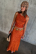 Orange Sequin Tank Top styled with a matching sequin skirt and a tan crochet beaded headpiece.
