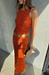 Thumbnail for Orange Sequin Tank Top with a racerback design, styled with a matching sequin skirt and a yellow statement belt.