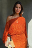 Orange Sequin Tilly Dress featuring shimmering burnt orange sequins and an asymmetric off-the-shoulder silhouette.