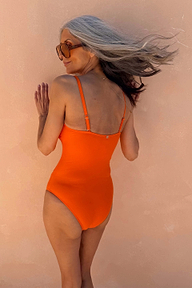 Orange Sun Bandeau Swimsuit with adjustable straps, shown from the back on a model for a beach vacation.