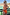 Thumbnail for Orange Sun Bandeau Swimsuit with adjustable straps, worn by a model looking over her shoulder at a beach resort.